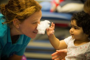 Child putting form on therapist's nose