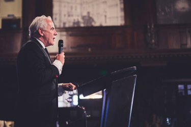 Man holding microphone speaking