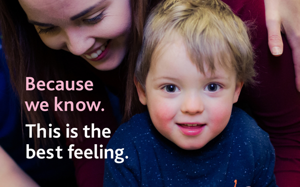 Child looking into the camera with mother. Text on the left reads Because we know (in pink),  This is the best feeling (in white).